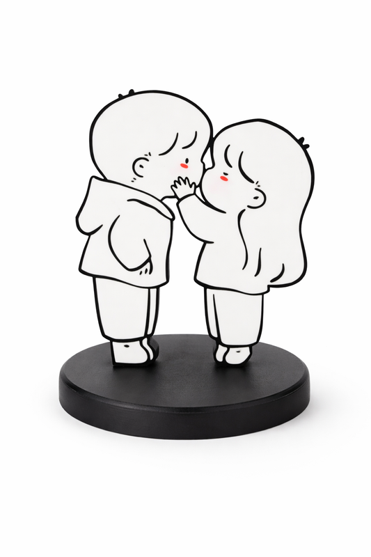 Black and white figurine of two people embracing on a black base
