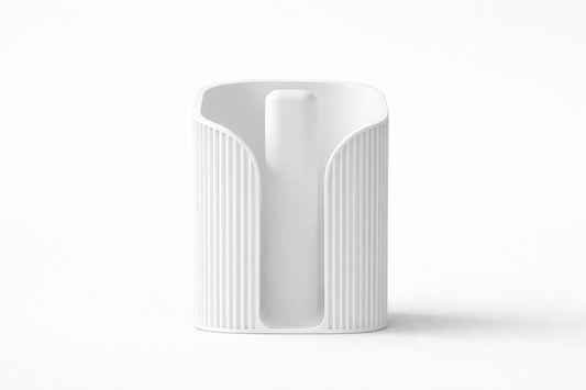 White ceramic vase with textured design on a white background
