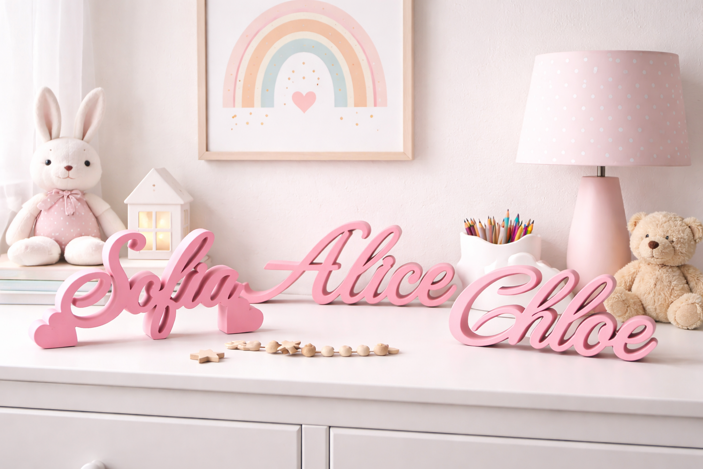 Pink name signs on a shelf with toys and decor in a child's room