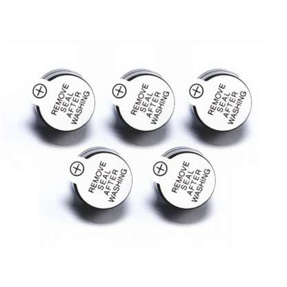 Five metal washers with 'Remove Seal After Washing' text on a white background