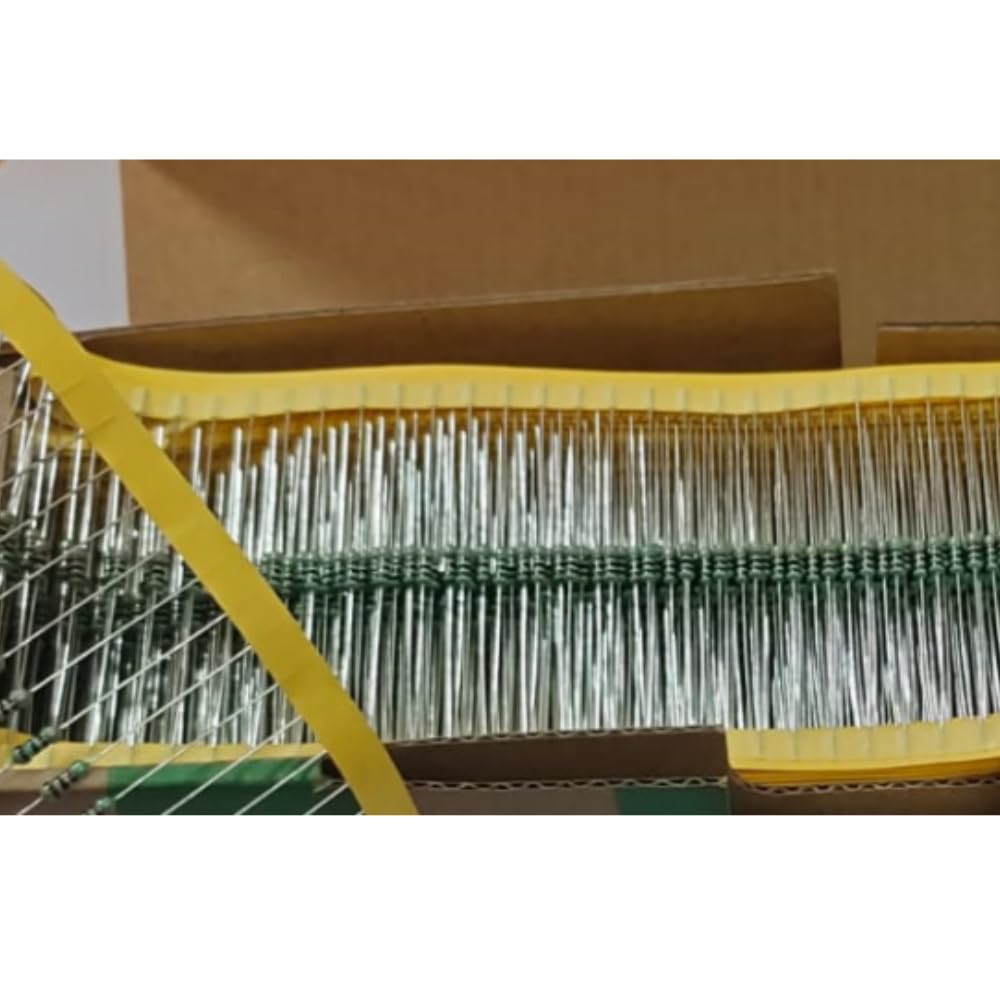 Close-up of a box containing electronic resistors with a yellow tool in the foreground.