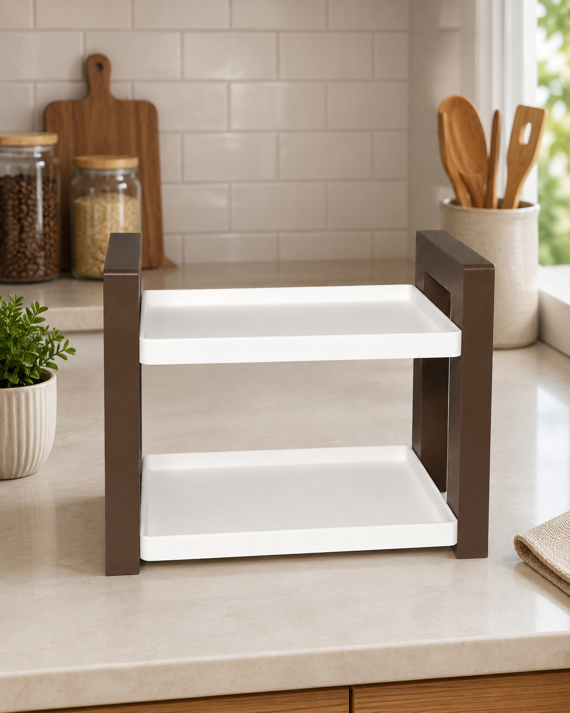 A two-tier kitchen organizer with white trays and dark brown side frames, set on a beige kitchen countertop.