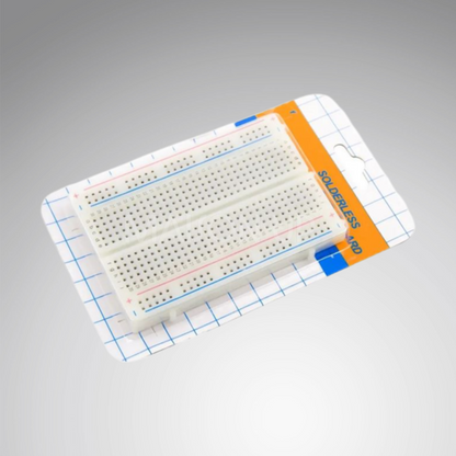 Solderless breadboard in packaging on a gray background