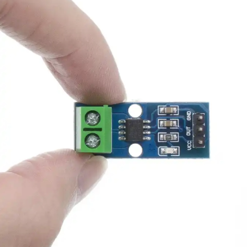 Circuit board module held between fingers on a white background