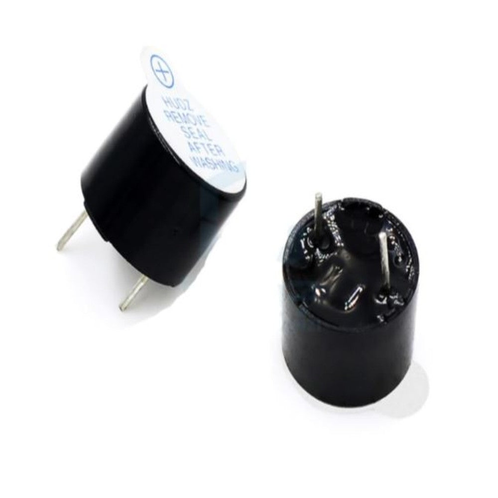 Two black cylindrical components with metallic contacts on a white background
