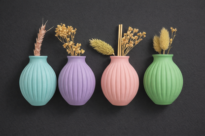 Four colorful vases with ribbed texture on a dark background