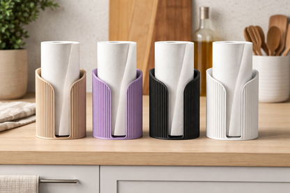 Set of four white cups in colorful holders on a kitchen counter.