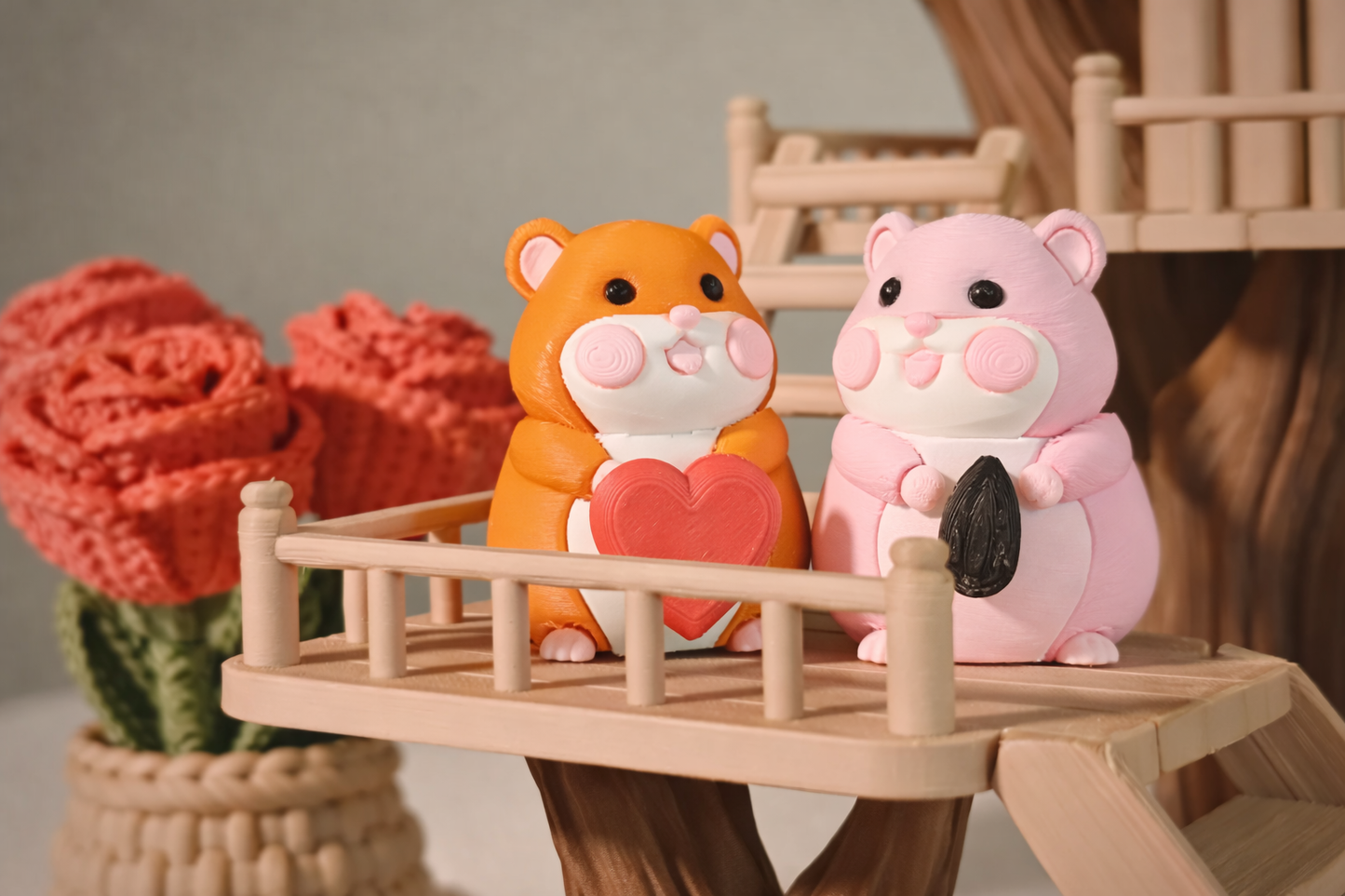 Two toy hamsters on a small wooden bridge with a blurred background