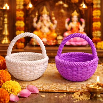 Two woven baskets, one white and one purple, on a decorative table with flowers and candles.