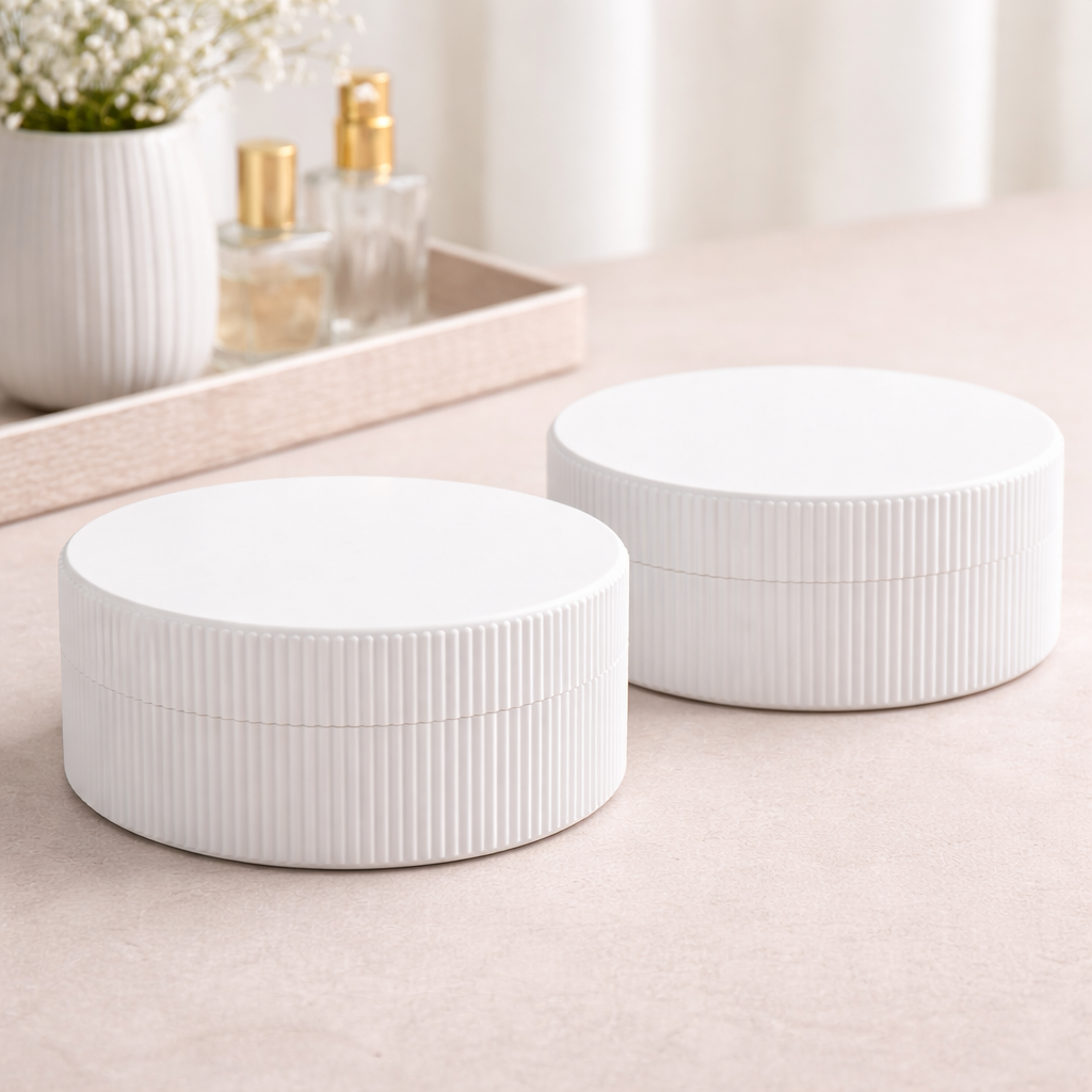 Two white ceramic bowls on a light surface with a blurred background