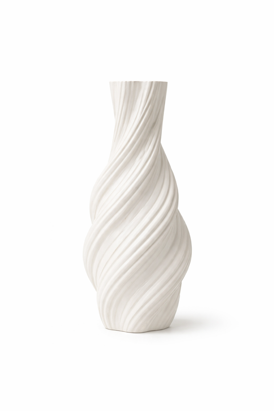 White ceramic vase with wavy design on a white background