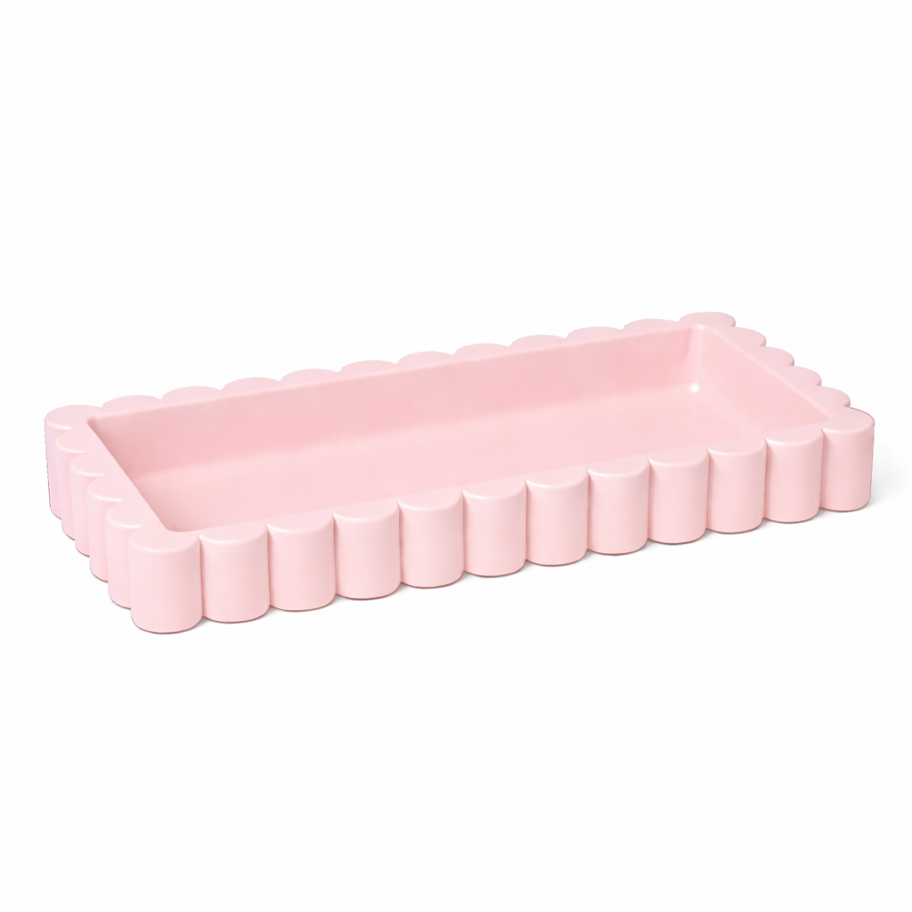 Pink rectangular tray with a wavy edge on a white background