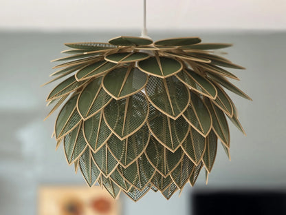 Decorative pendant light with leaf-like design on a blurred background
