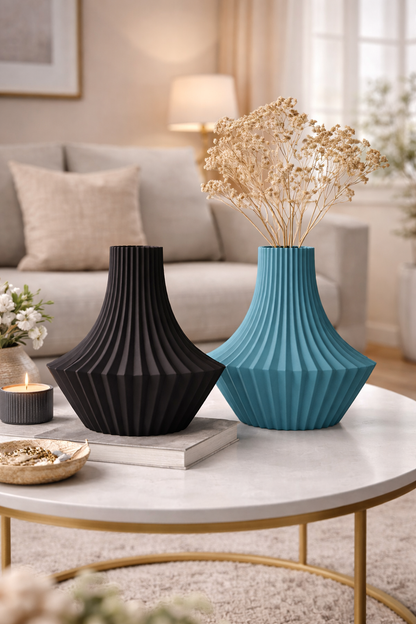 Two vases, one black and one blue, on a coffee table in a living room.