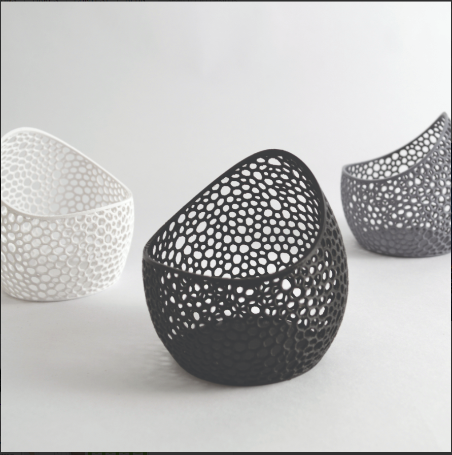 Three decorative bowls with unique perforated designs on a light gray background