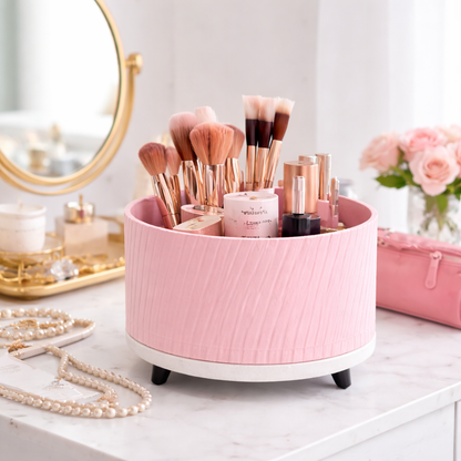 Pink makeup organizer with brushes and products on a vanity table.