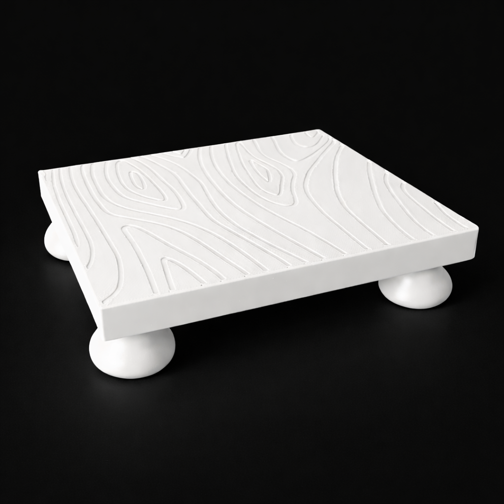 White decorative platform with rounded legs on a black background
