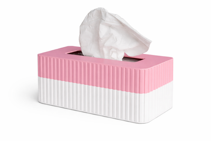 Pink and white tissue box with tissues peeking out on a white background