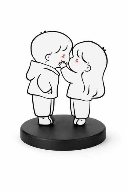 Black and white figurine of two people embracing on a black base