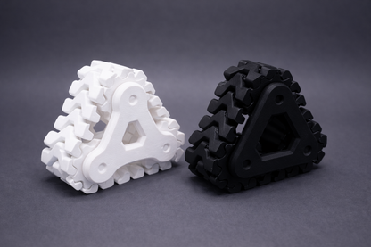 White and black triangular gear-like objects on a gray background