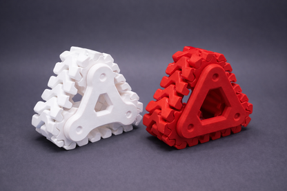 White and red triangular puzzle pieces on a dark gray background