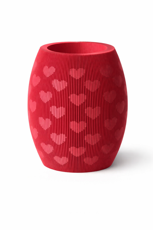 Red textured vase with heart patterns on a white background