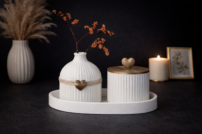 Decorative setting with white vases and containers on a dark background
