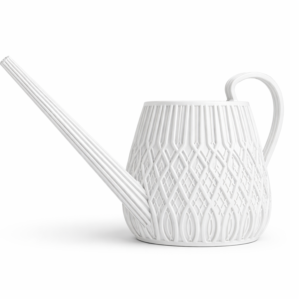 White ceramic watering can with decorative pattern on a white background