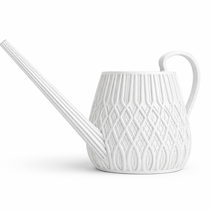 White ceramic watering can with decorative pattern on a white background