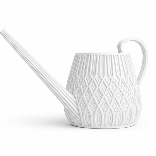 White ceramic watering can with decorative pattern on a white background