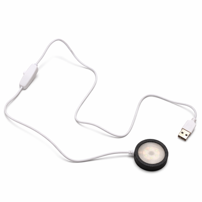 Round USB light with a cable on a white background