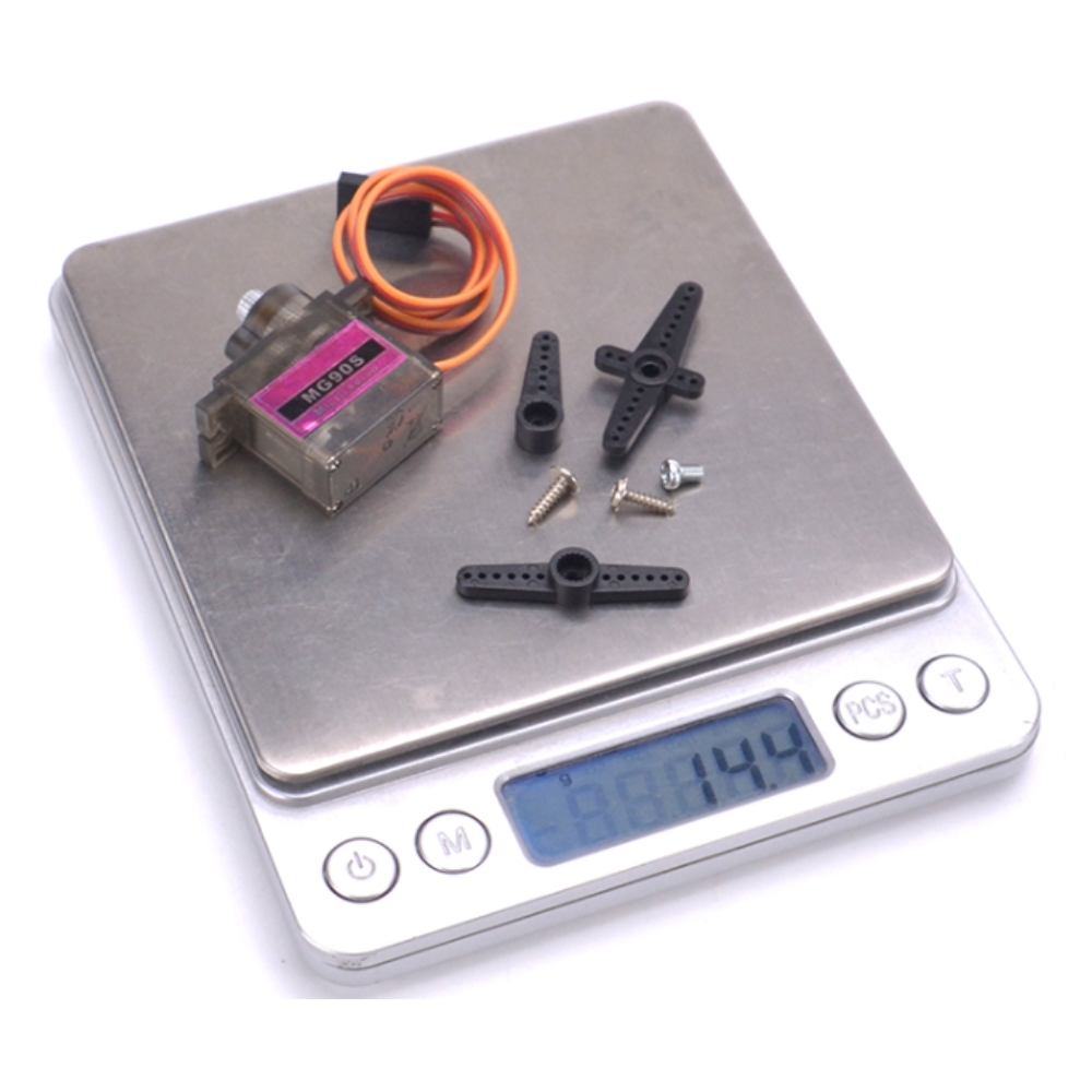 Small electronic components on a digital scale with a white background