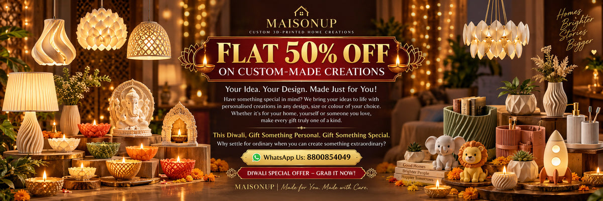 A promotional banner for Maisonoup featuring a 'Flat 50% Off on Custom-Made Creations' offer. The image showcases a collection of warm, glowing home decor items including string lights, hanging lamps, candles, and gift boxes arranged symmetrically on both sides of a central dark banner with white and gold text.