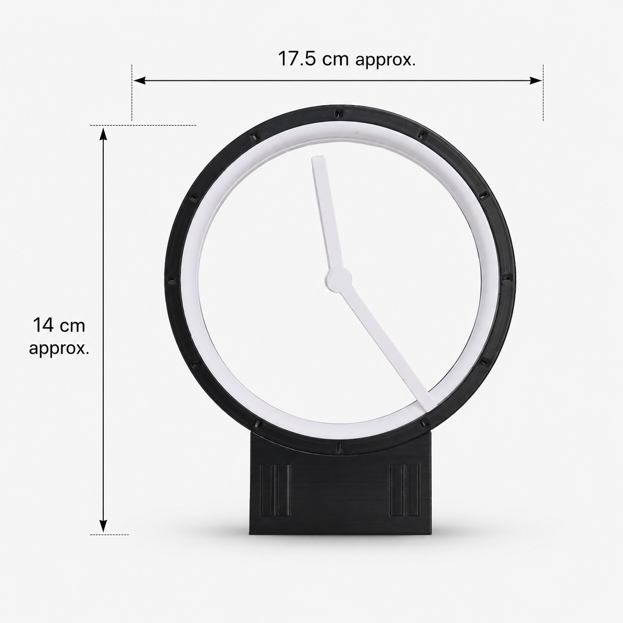 A minimalist round wall clock with a black frame and stand, white clock face and hands, shown with dimension lines indicating approximately 17.5 cm width and 14 cm height on a light gray background.