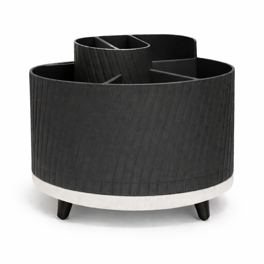 Black cylindrical planter with white base on a white background