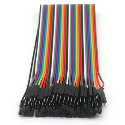 Set of rainbow-colored wires with black connectors on a white background