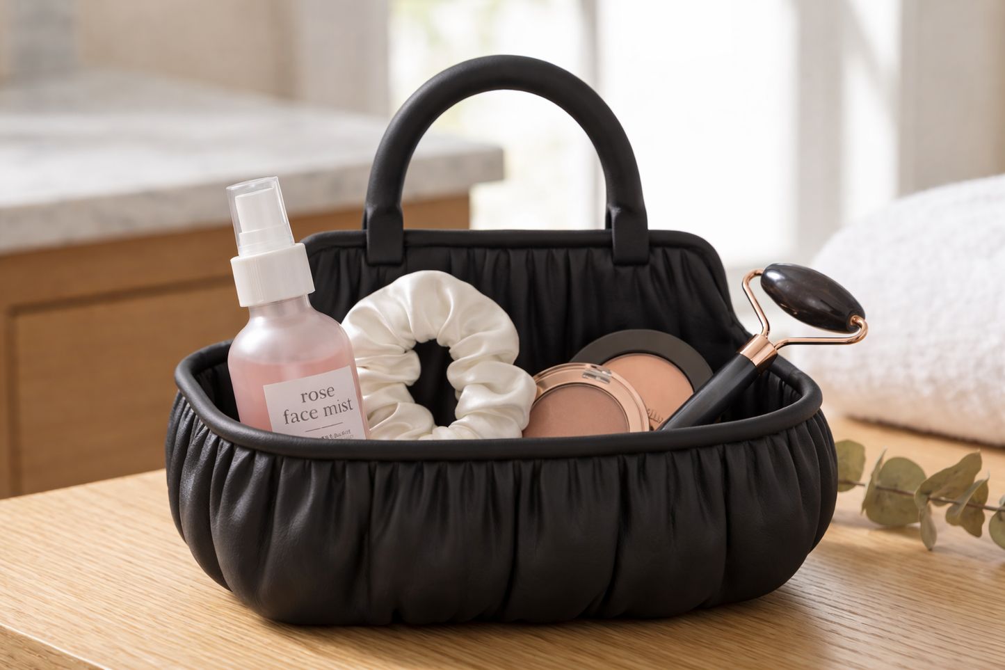 Black basket with beauty products including a bottle, scrunchie, and roller on a wooden surface.