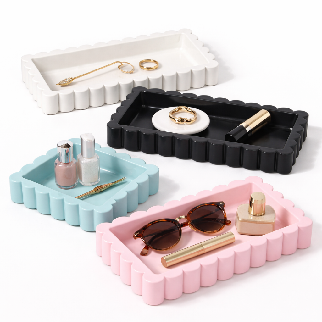 Set of four colorful trays with small items on a white background