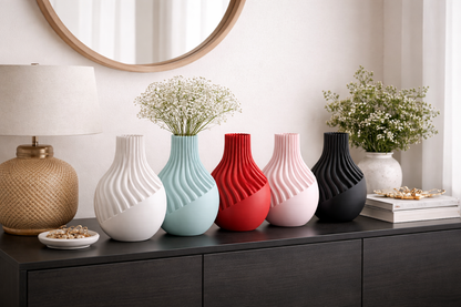 Colorful vases on a dark wooden surface with a mirror and decorative items in the background.