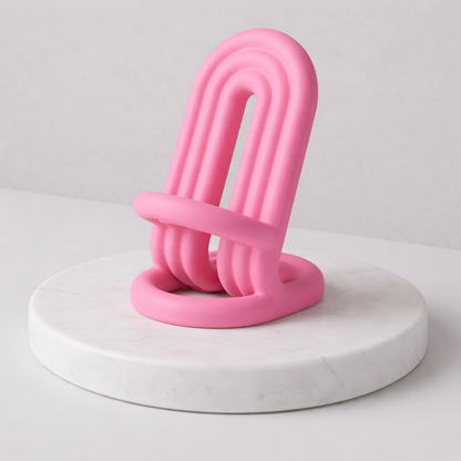 Pink abstract sculpture on a white marble base