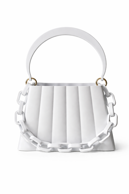 White handbag with decorative chain details on a white background