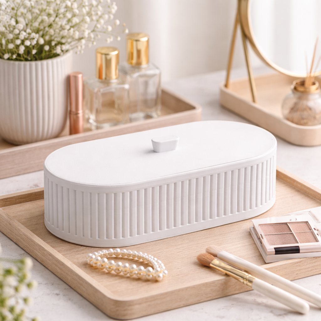 White jewelry box on a wooden tray with beauty products in the background