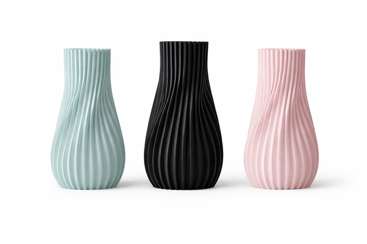 Three textured vases in green, black, and pink on a white background