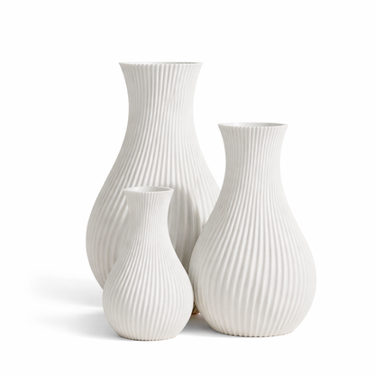 Set of three white ribbed vases on a white background