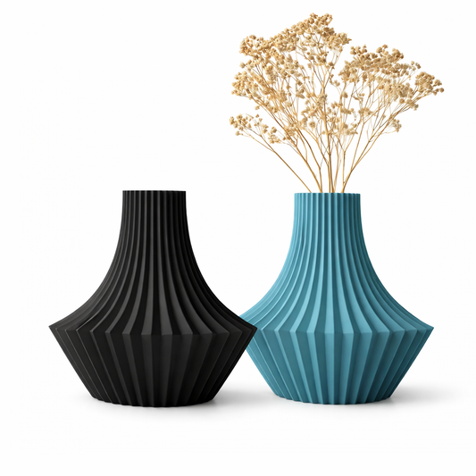 Black and blue textured vases with dried flowers on a white background