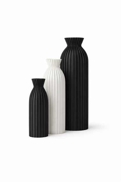 Three black and white vases of different sizes on a white background