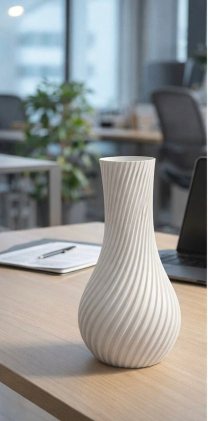 White textured vase on a wooden surface with a blurred office background