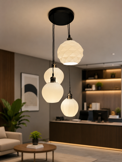 Modern pendant light fixture with glass shades in a living room setting.