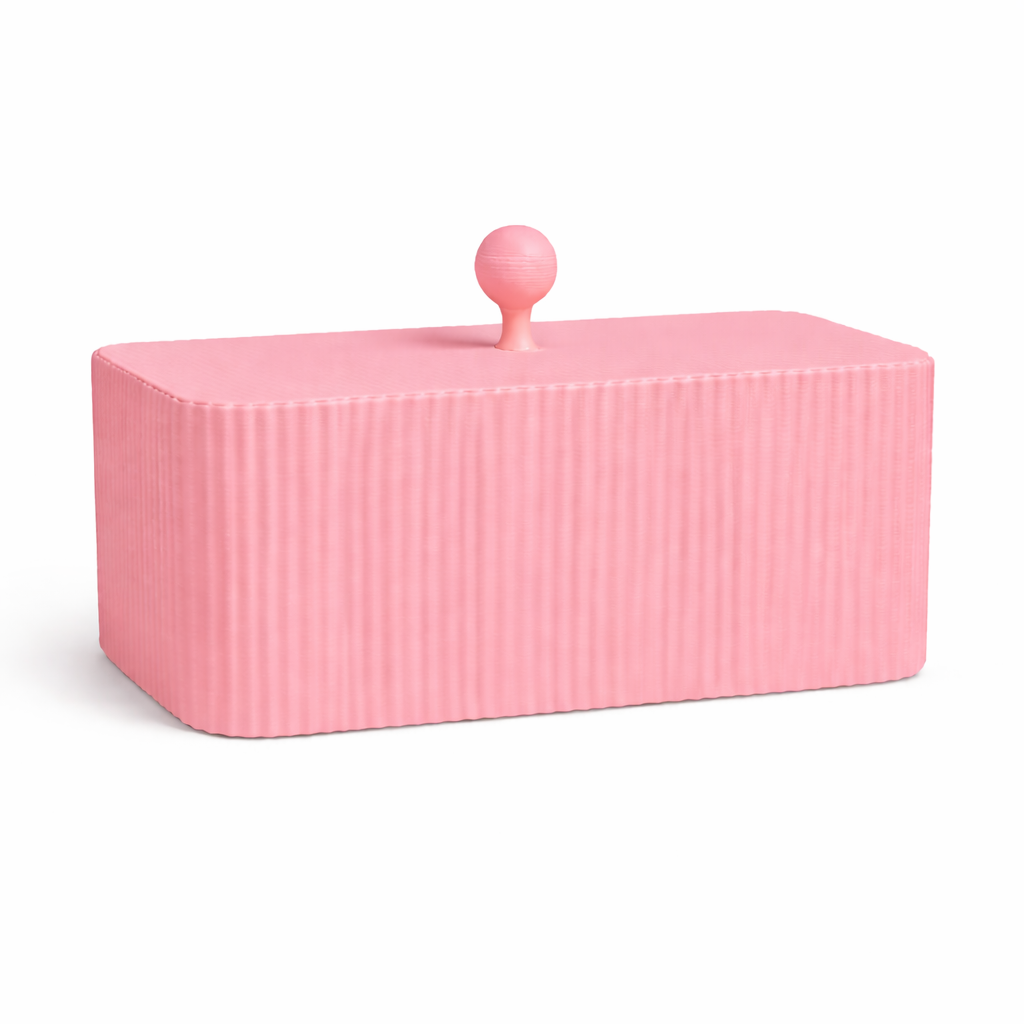 Pink ribbed container with a lid on a white background