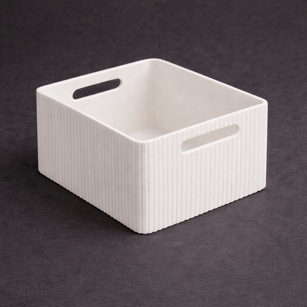 White rectangular storage basket with ribbed texture on a dark background